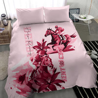 Pink duvet and two pillows with red horse rider, floral lily accents