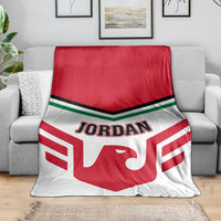Red and white football blanket with Jordan logo draped over gray couch
