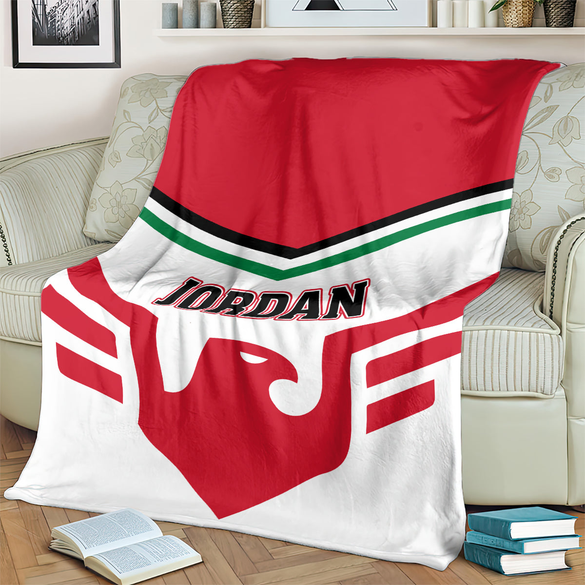 Red-and-white Jordan logo football blanket folded on striped couch