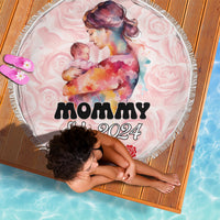 Pink round beach blanket with fringe, mother and baby art with “MOMMY Est. 2024”