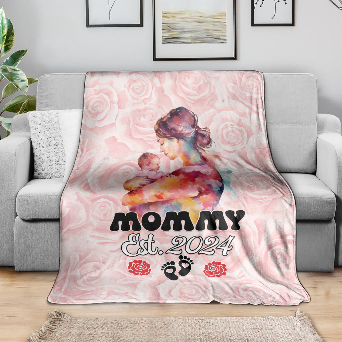 Pink mother’s day blanket draped over sofa, Mom Est. 2024 with roses and paw