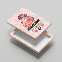 Pink canvas wall art folded on easel, mom and baby with MOMMY Est. 2024 text
