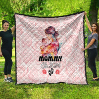 Pink quilt on outdoor grass featuring mom-and-baby artwork and 'Mommy Est. 2024'.