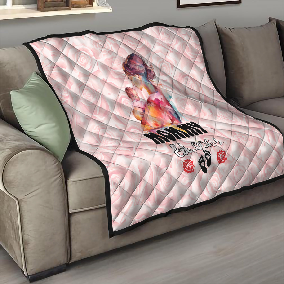 Pink diamond-quilt blanket on a sofa with mom-and-baby design and floral paw prints.