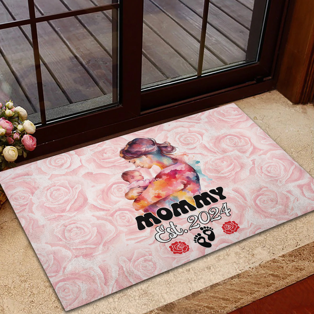 Pink rubber doormat with mom-and-baby artwork and “Mommy Est. 2024” on rose background