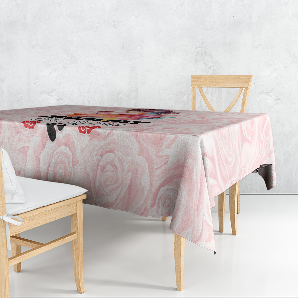 Pink rose-pattern tablecloth draped over dining table
