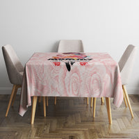 Pink rose-pattern tablecloth on rectangular dining table with four chairs