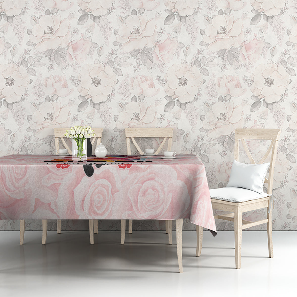 Pink rose-pattern tablecloth on dining table with chairs and small centerpiece