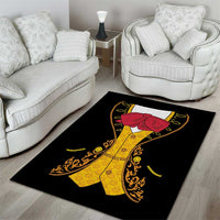Black area rug with red mariachi hat, yellow charro suit, and ornate gold patterns