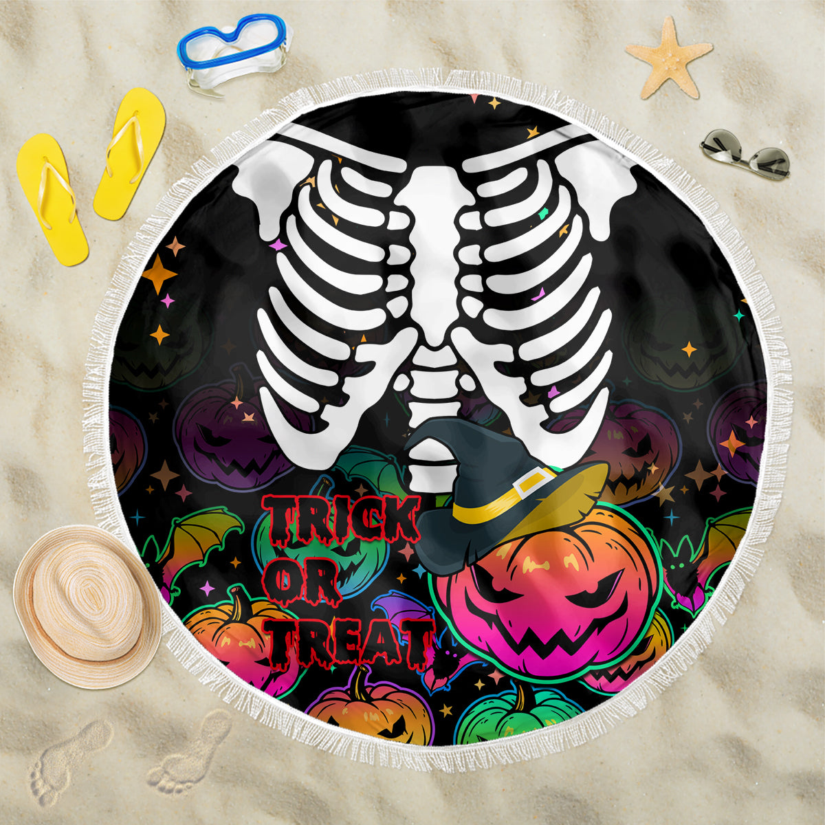 Round black Halloween beach blanket with white skeleton ribs, pumpkins and “Trick or Treat” text