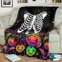 Black skeleton blanket with large white ribcage print and trick-or-treat pumpkins