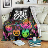 Black Halloween skeleton blanket on sofa with colorful jack-o'-lanterns and 'Trick or Treat'
