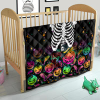 Black Halloween skeleton quilt in a crib with colorful pumpkins and 'Trick or Treat' design