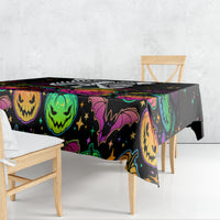 Black Halloween tablecloth draped over table with colorful jack-o’-lantern and bats