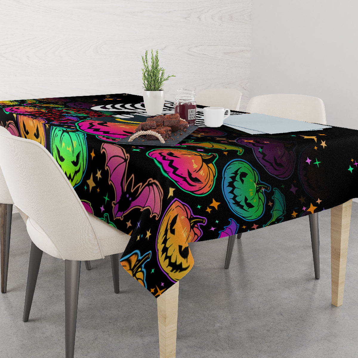 Black Halloween tablecloth with colorful jack-o’-lantern, bats, and star accents