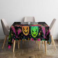 Black Halloween tablecloth with neon green and purple jack-o’-lantern faces and stars