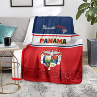 Panama-themed blanket coat draped on couch, red bottom with dark floral pattern, Panama text