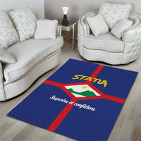 Blue area rug on hardwood floor with red cross, STATIA crest and text