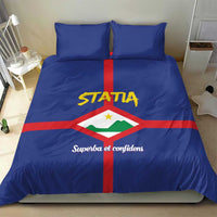Blue bedding set with STATIA logo, red cross center stripe, and two matching pillowcases
