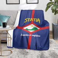 Blue Statia coat of arms blanket on a chair, with red cross and script slogan