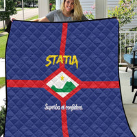 Blue quilt with red cross and Statia crest, quilted diamond pattern, with yellow STATA text
