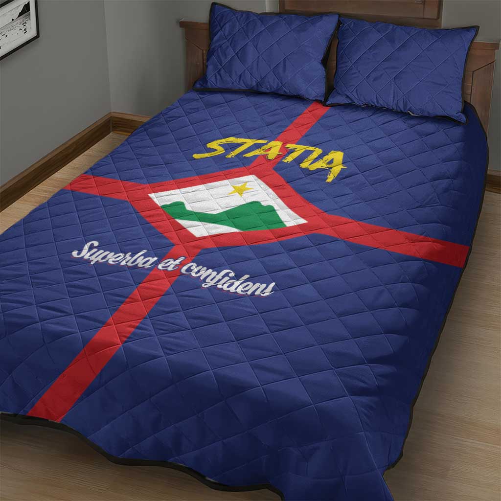 Blue quilt bed set with two pillowcases, STATIA lettering centered over red and green cross