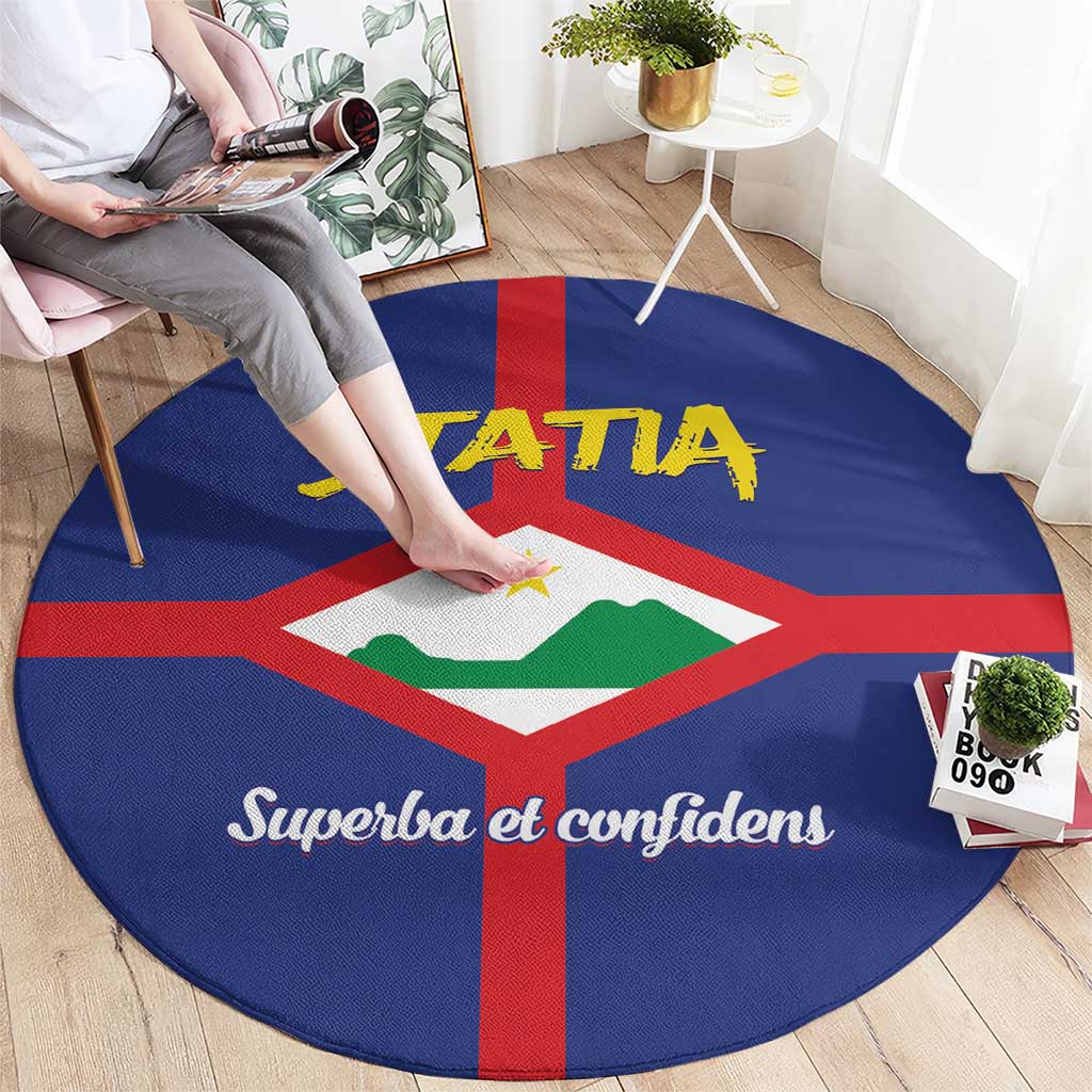 Round blue carpet with red cross center emblem, yellow STATA lettering, and white script