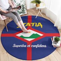 Round blue carpet with red cross center emblem, yellow STATA lettering, and white script