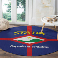 Round blue area rug showing STATA text, red cross, and green coat of arms emblem
