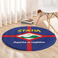 Round blue rug with STATA title, red cross, and coat of arms in green and white