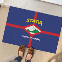 Blue rubber doormat with coat of arms and STATIA branding on outdoor tiles
