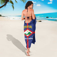 Blue sarong draped on back with STATIA logo, red cross, and coat of arms crest