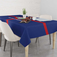Blue tablecloth with red cross detail, crest graphic on tabletop center.