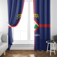 Blue window curtain panels with coat of arms print, red stripe, and yellow letters