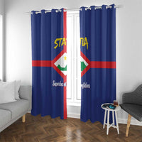 Blue window curtains with metal hook loops and vertical Sint Eustatius coat of arms emblem