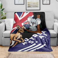 Kangaroo and koala Australia-themed blanket draped on sofa, navy and black graphic design