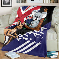Kangaroo and koala Australia-themed blanket on couch, dark navy and black with bold stripes