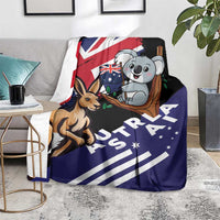 Kangaroo and koala Australia-themed blanket on living room chair, navy and black artwork
