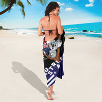 Dark navy sarong with koala graphic and kangaroo, draped as a wrap