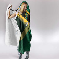 Jamaica hooded blanket with white sherpa trim and shield crest on green and black