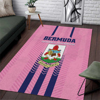 Pink area rug with navy vertical stripes and centered Bermuda crest logo