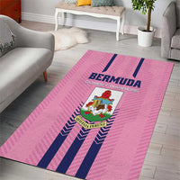 Pink area rug with navy stripes and centered Bermuda crest logo on the floor