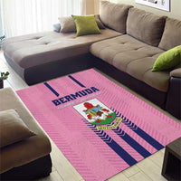 Pink Bermuda-themed area rug with navy stripes and crest logo, corner view