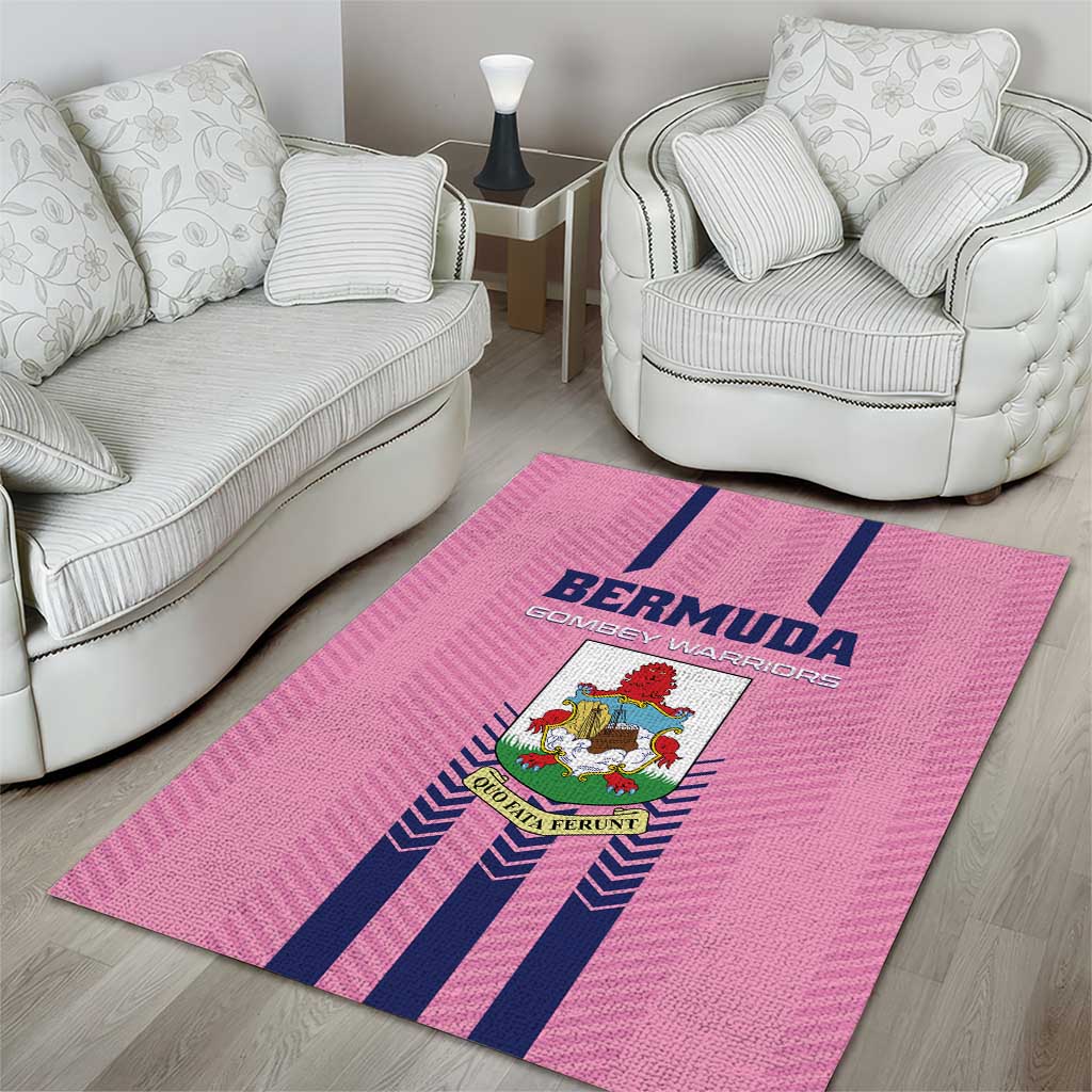 Pink area rug with Bermuda logo and navy stripes on hardwood near seating