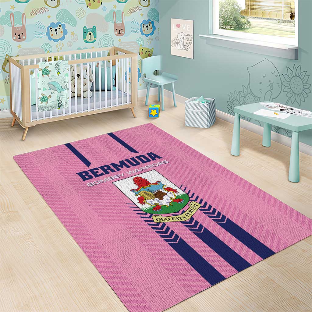 Pink area rug with navy stripes and crest logo in a kids room on wood floor