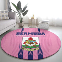 Pink round area rug with Bermuda text and crest center, blue vertical stripe accents