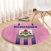 Pink round rug with Bermuda crest, blue and navy vertical stripe design