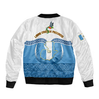 White and blue bomber jacket with central coat of arms, blue Maya-style bands on back