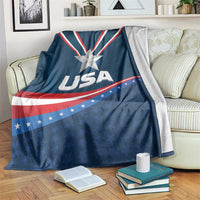 Blue USA-themed fleece blanket draped over a couch, with star emblem and USA text