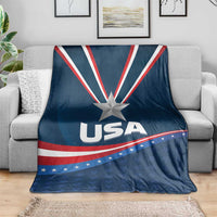 Blue USA-themed blanket over a gray sofa, with star emblem, stripes, and USA text